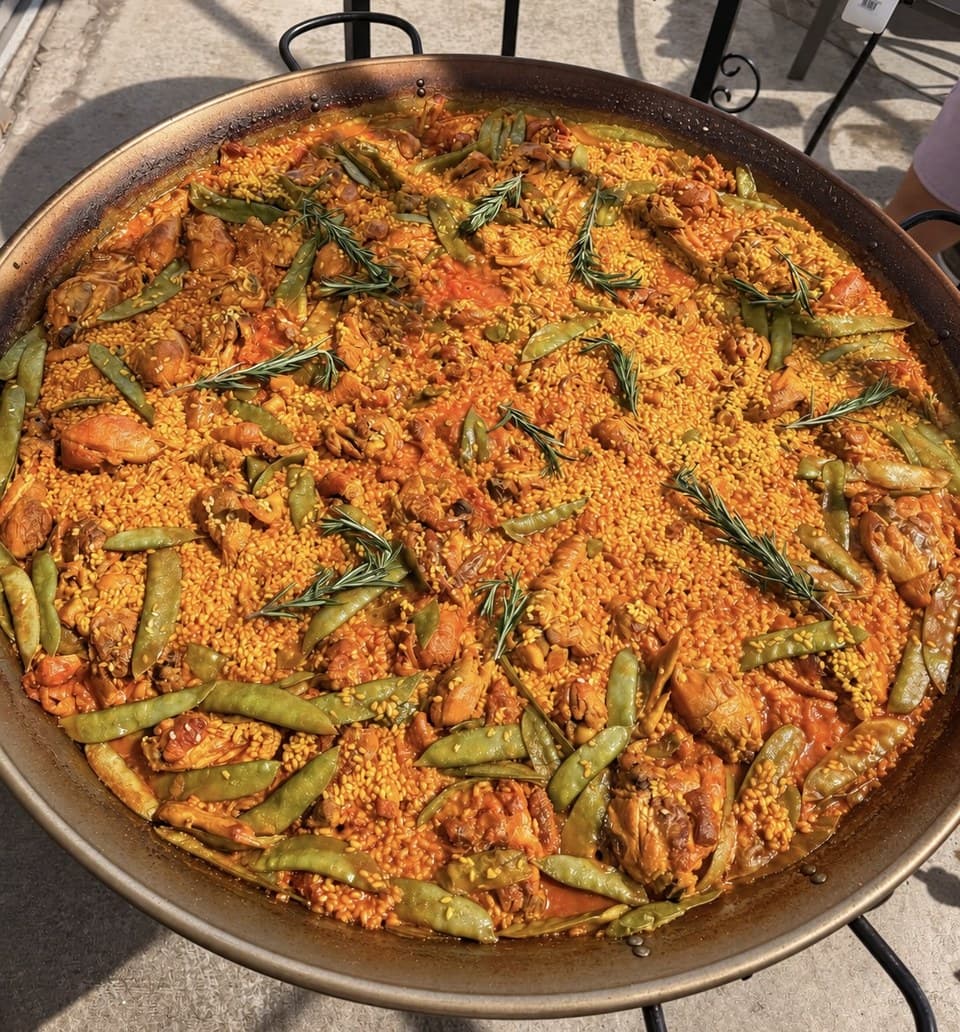 Traditional Valencian paella with chicken, green beans and rosemary