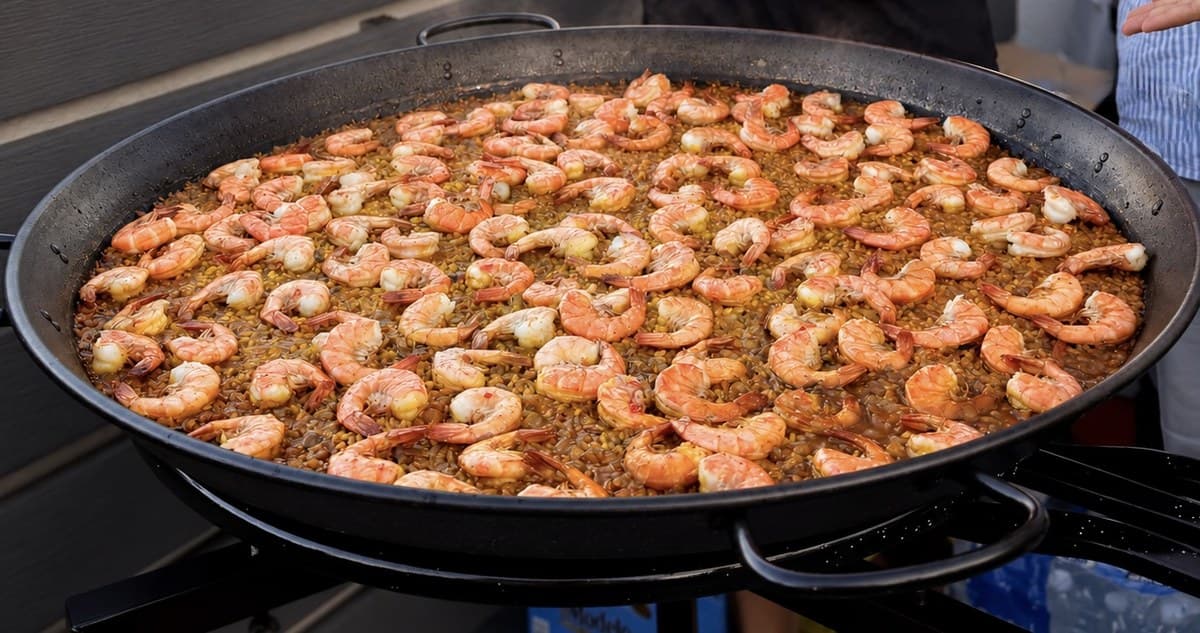 Shell-free shrimp paella, close up, steam rising from the pan